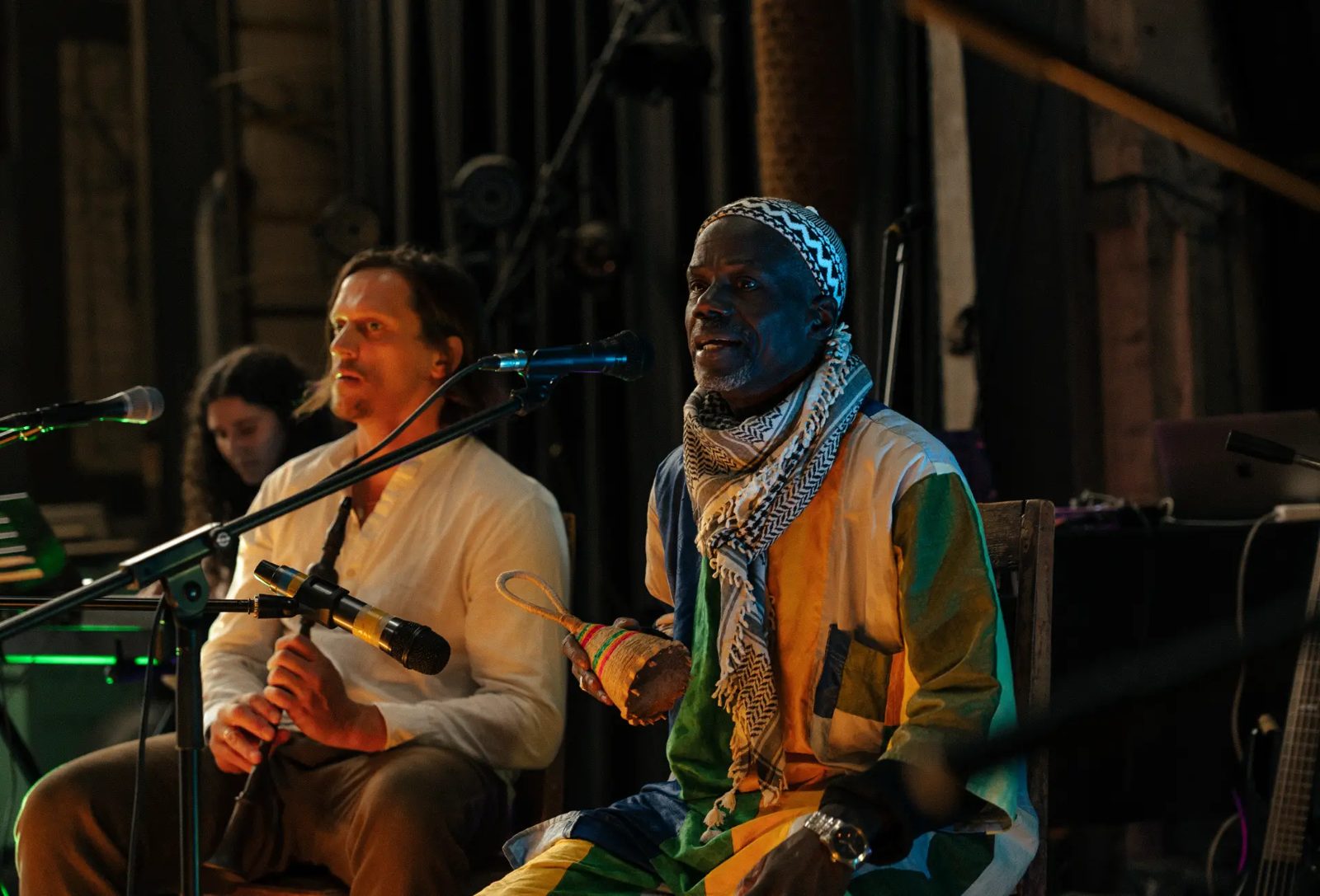 Mamadou Sene singing on stage with fellow musicians